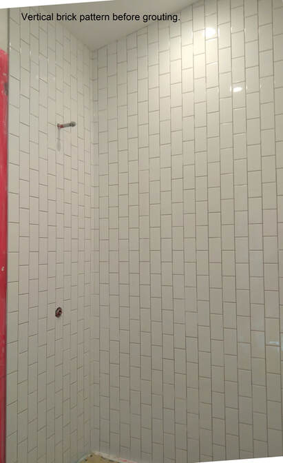 Subway tile installed in a vertical brick pattern in a shower enclosure 